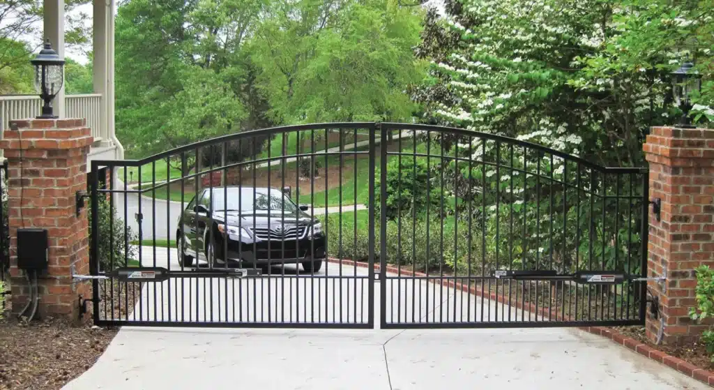 black wrought iron swing gate with car outside