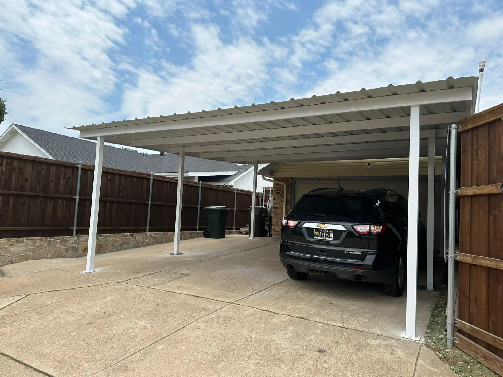 metal carport with car below it