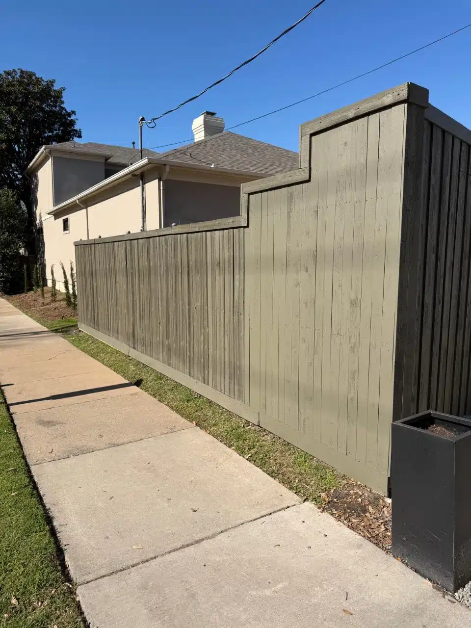 Cedar privacy fence running along the sidewalk at a Highland Park home