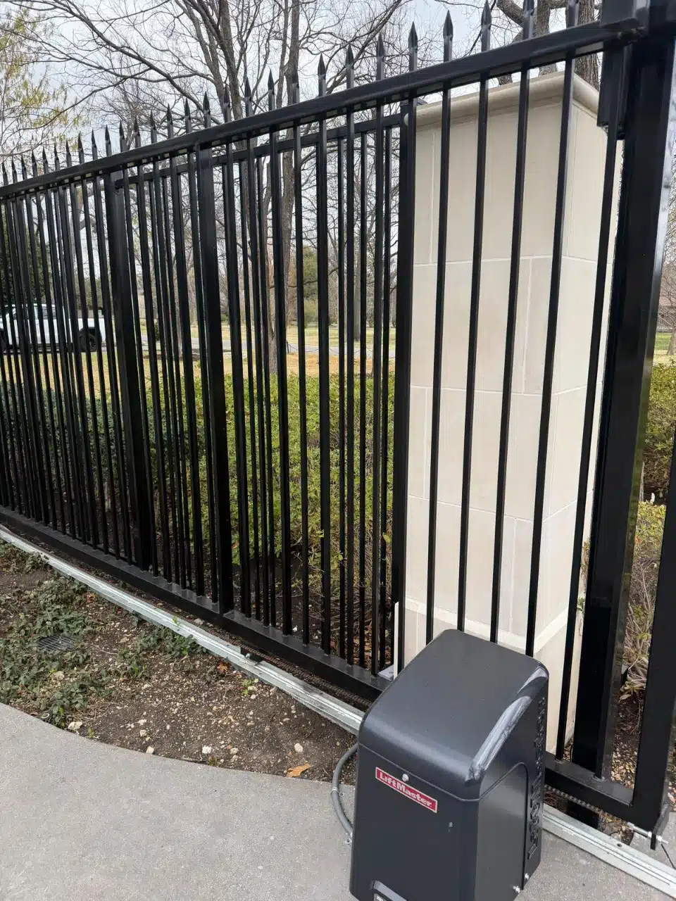 Close view of the eight-foot iron picket panels and stucco column