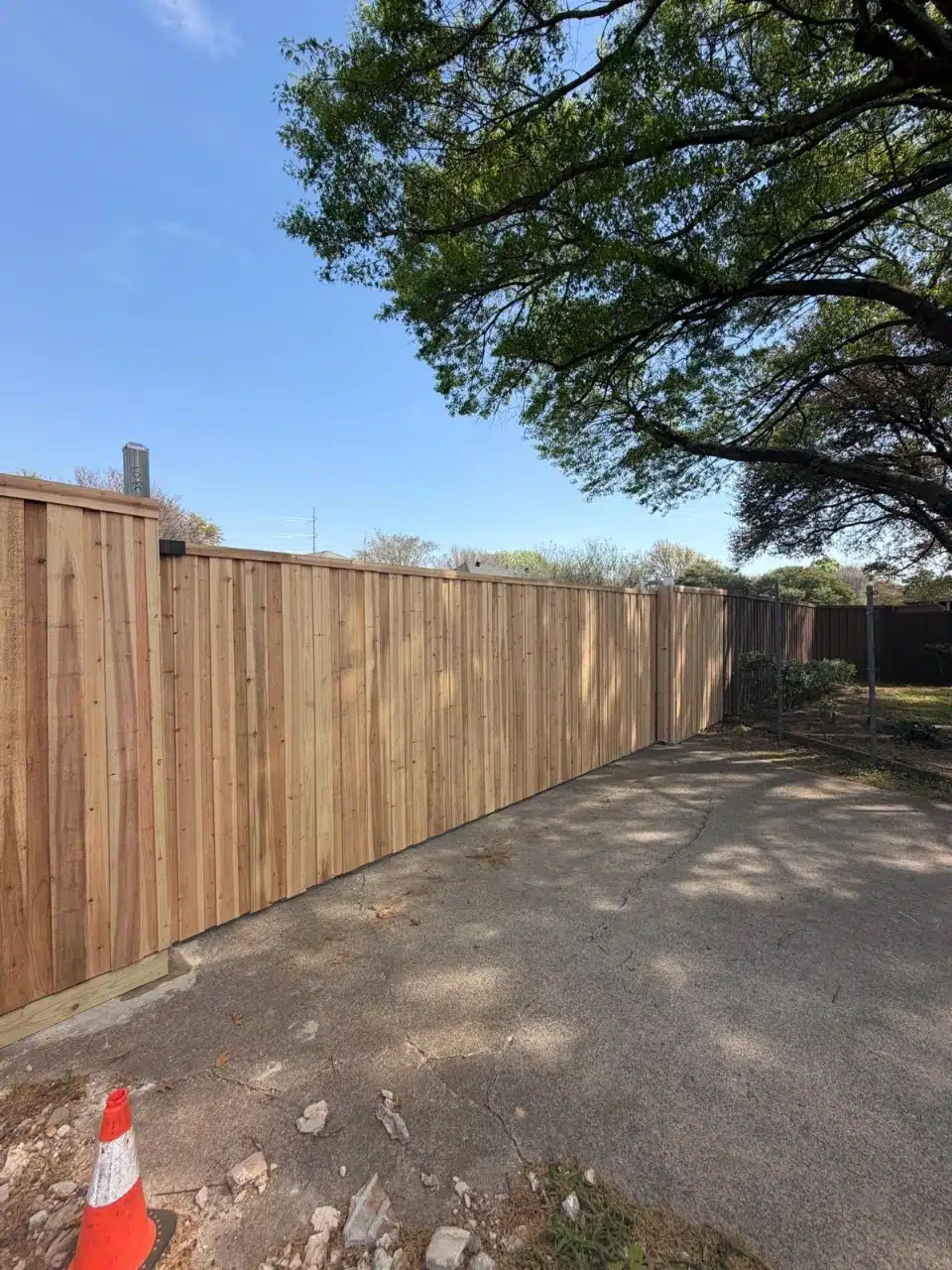 Cedar gate and fence line running along the driveway