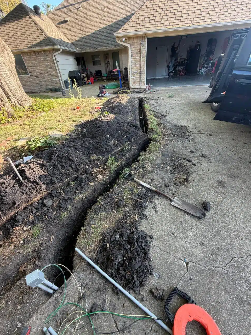 Trench dug across the yard for the 50-foot electrical run to the gate