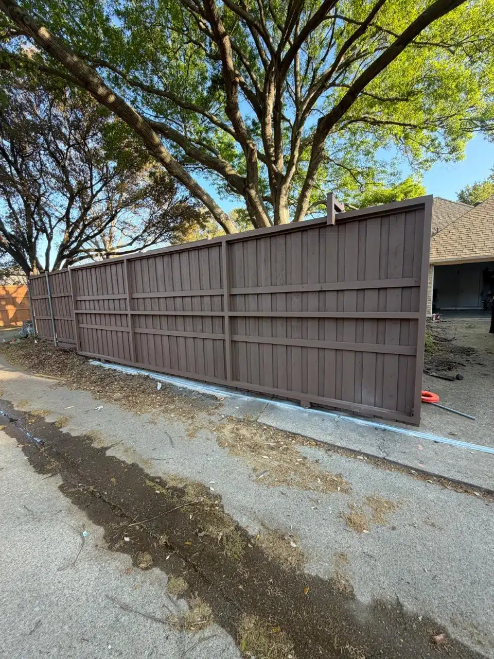 28-foot cedar sliding gate closed across a driveway in Richardson, Texas