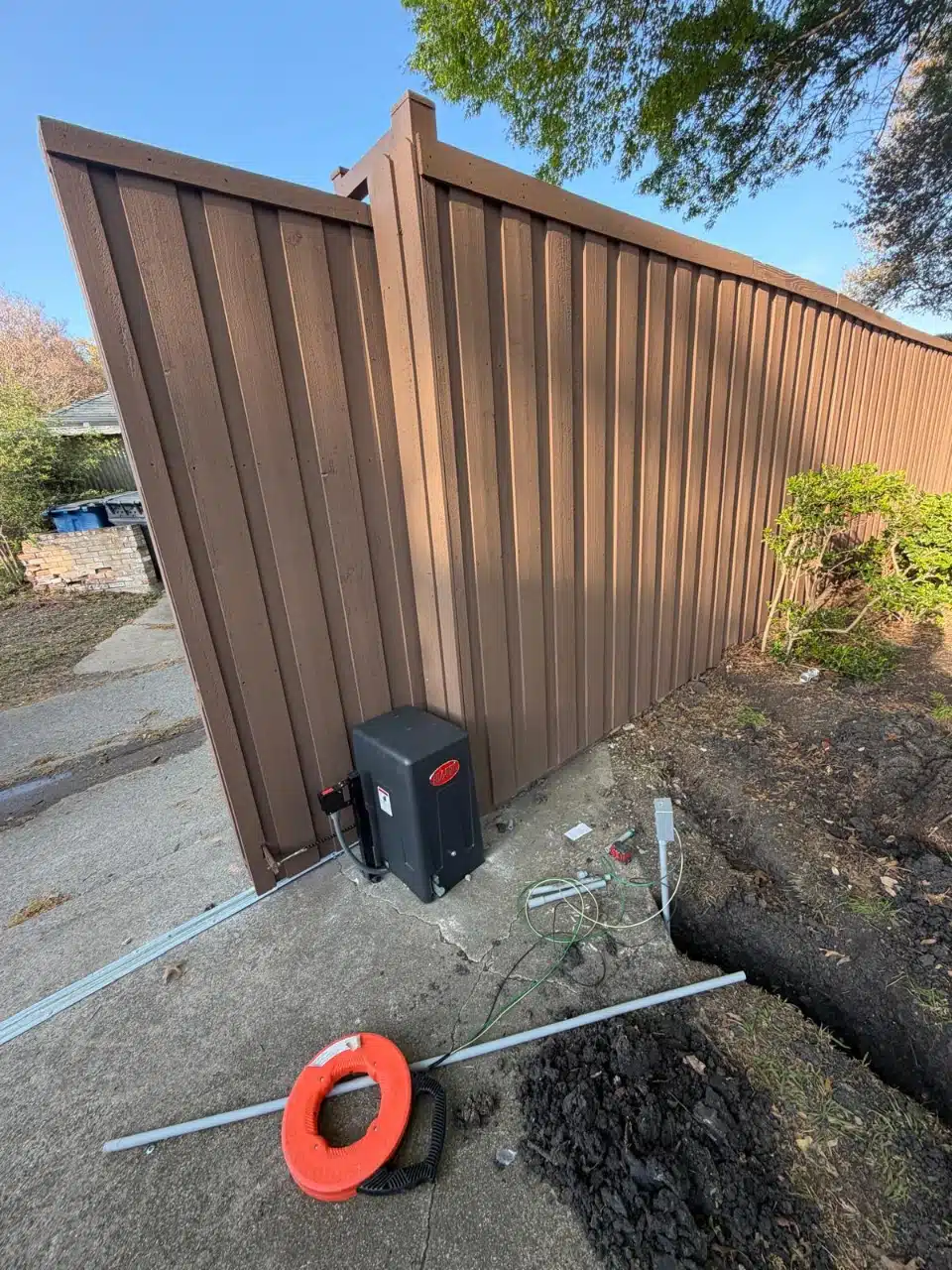 All-O-Matic SL100 slide gate operator set at the end of the cedar gate