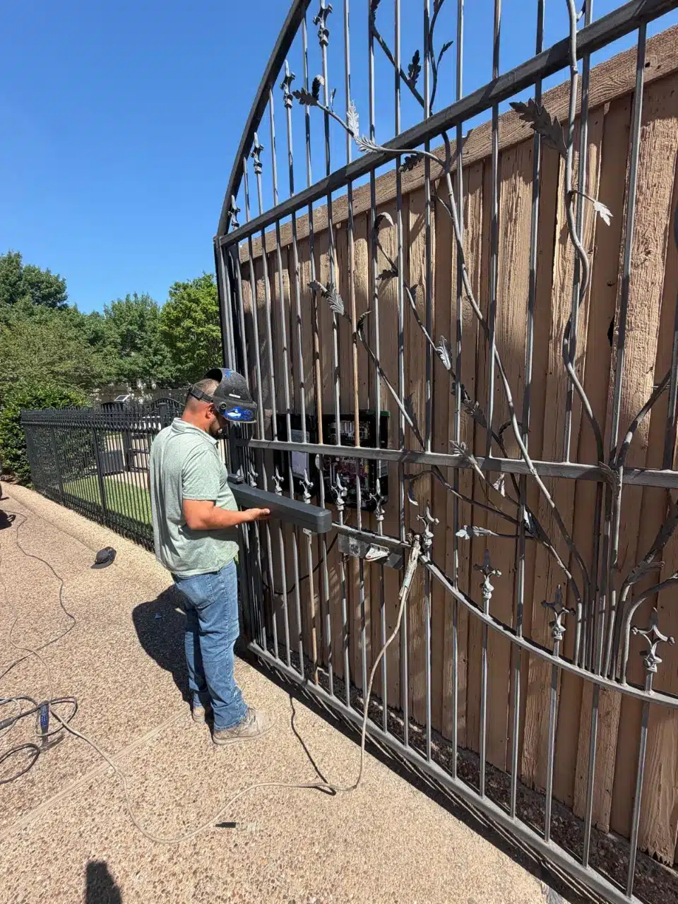 Star Gate and Fence technician working on the iron gate panel