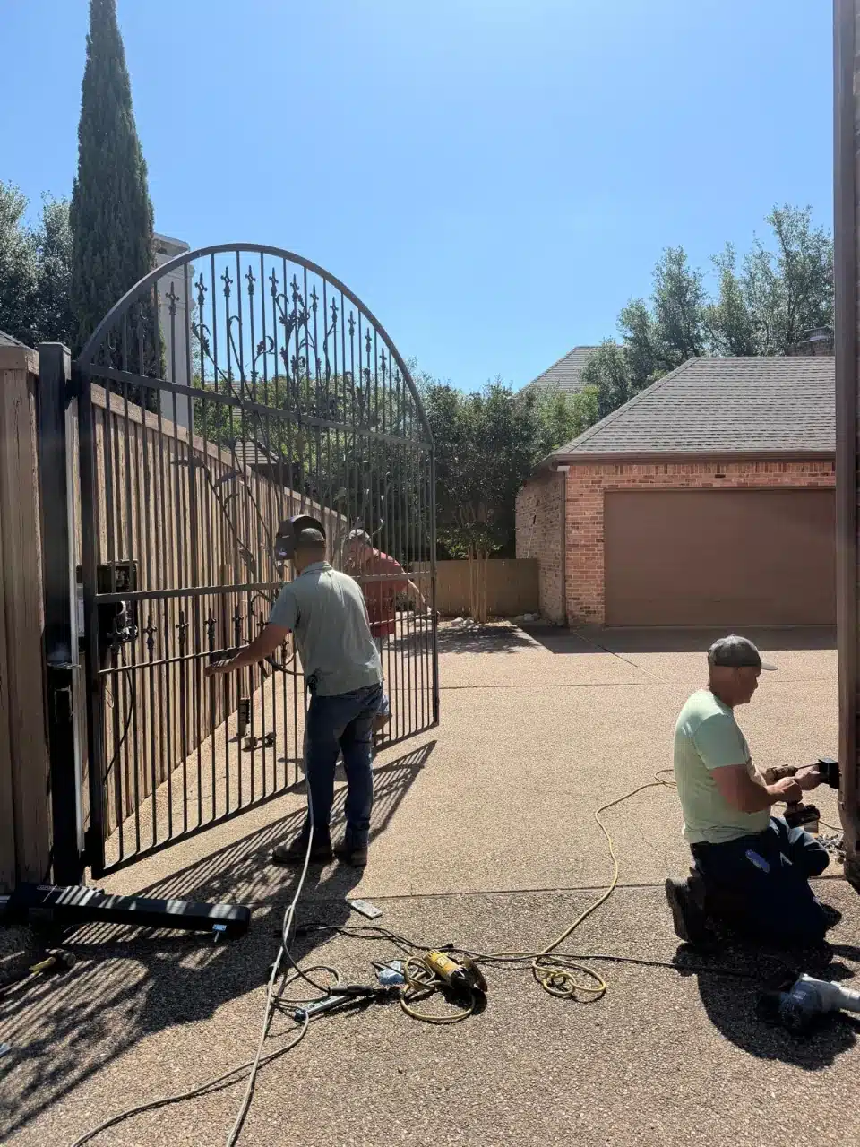 Crew installing a LiftMaster LA500 operator at the gate post