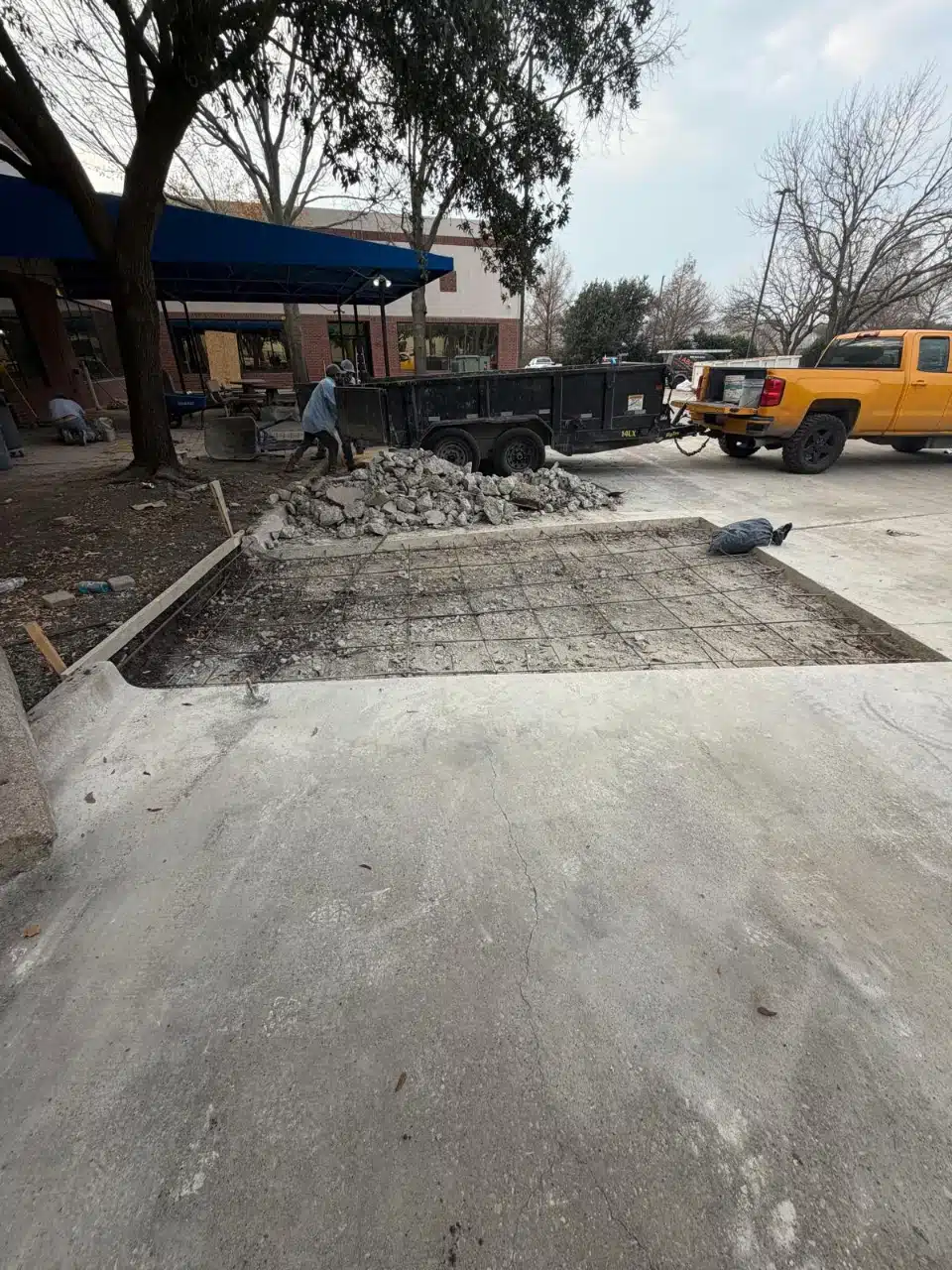 Failed concrete broken out of a commercial lot ready for replacement