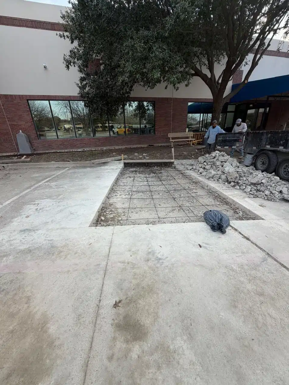 Rebar grid set in a cut-out section of commercial parking lot before the pour