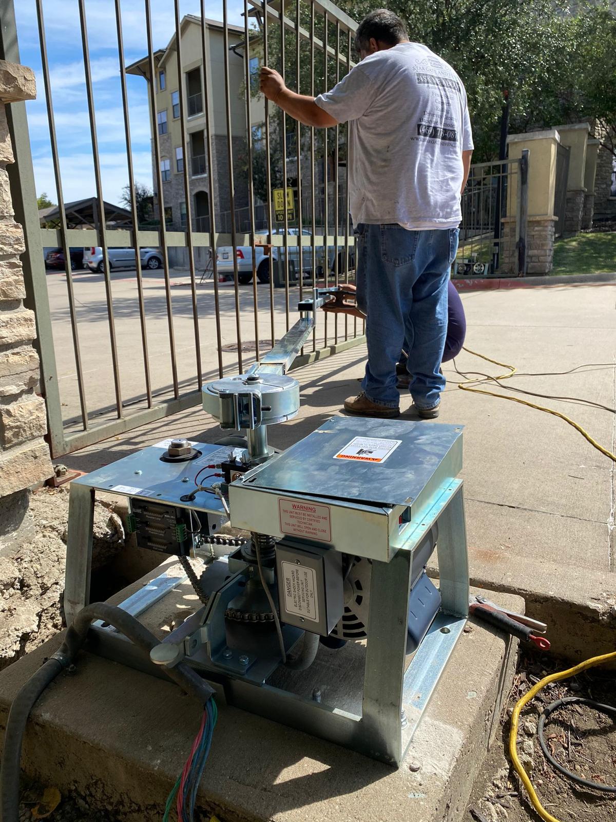 Technician working on the gate operator at the community entrance