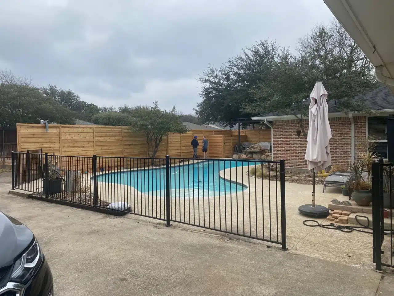 Four-foot flat-top iron fence enclosing a backyard pool