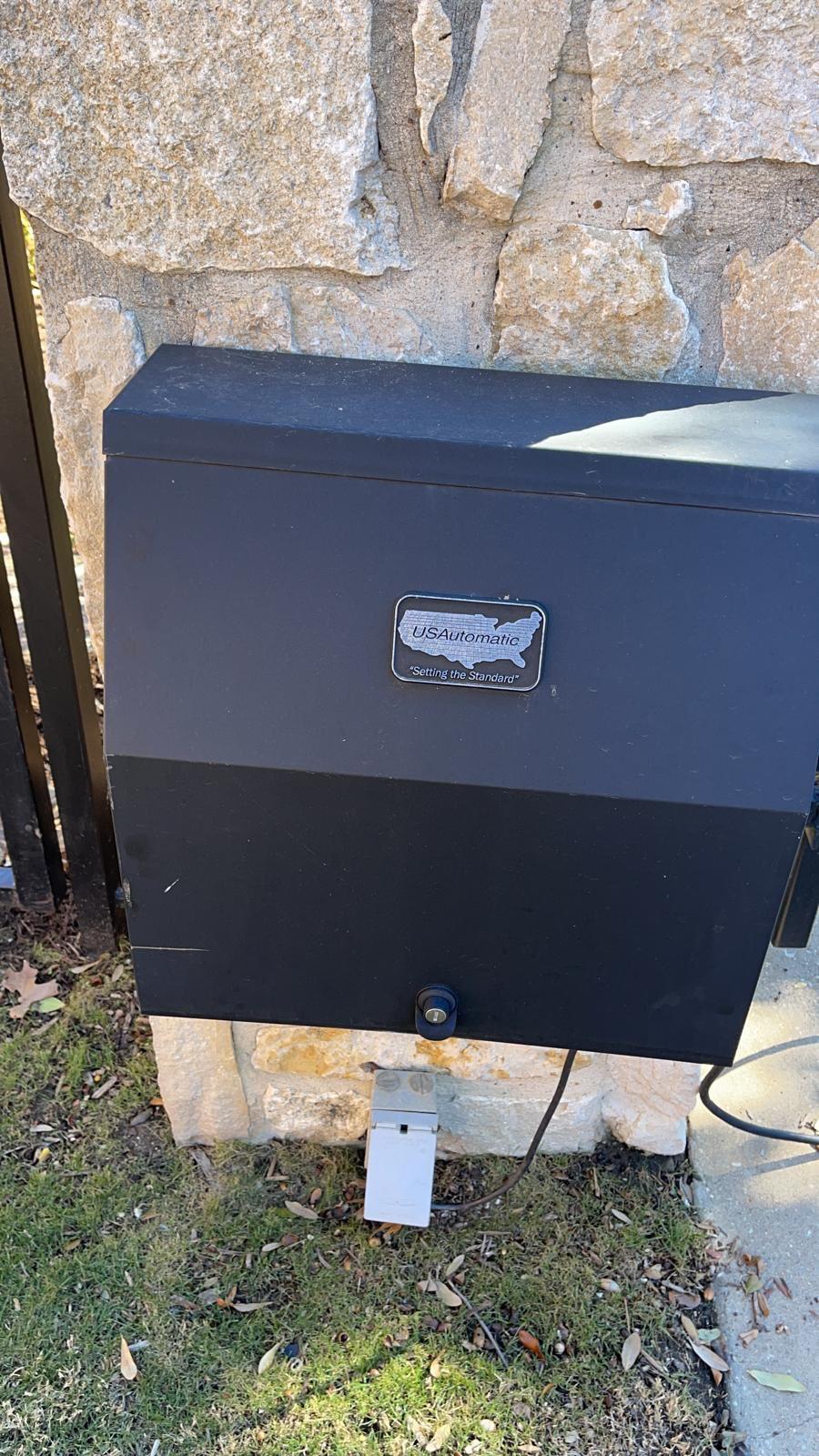 Weather-sealed USAutomatic operator and battery enclosure at a gate