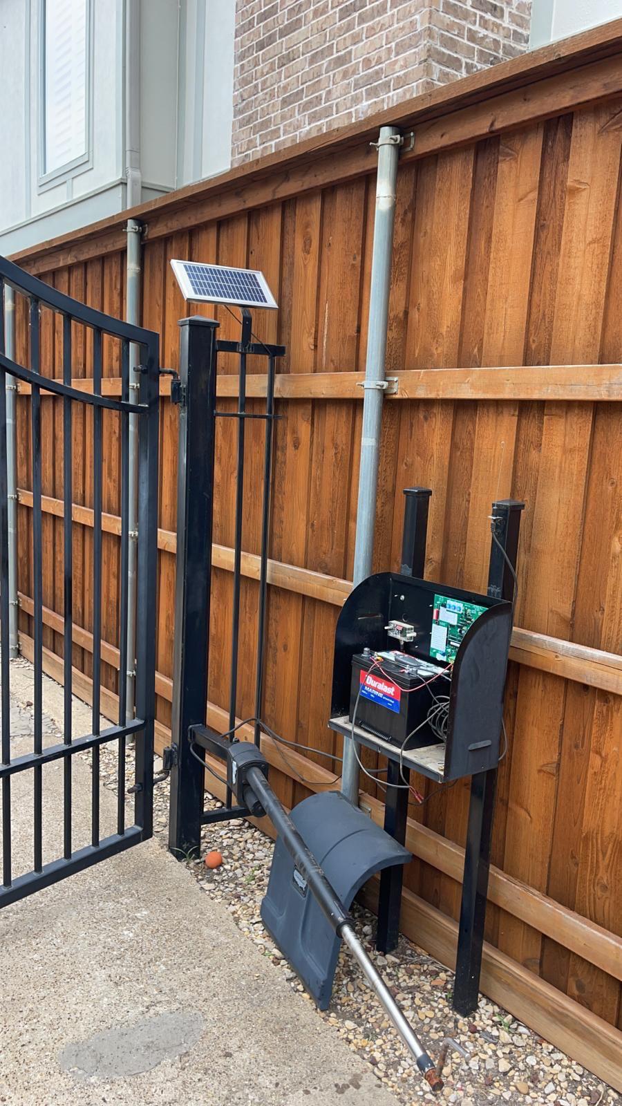 Solar panel and control box fitted beside a USAutomatic powered gate