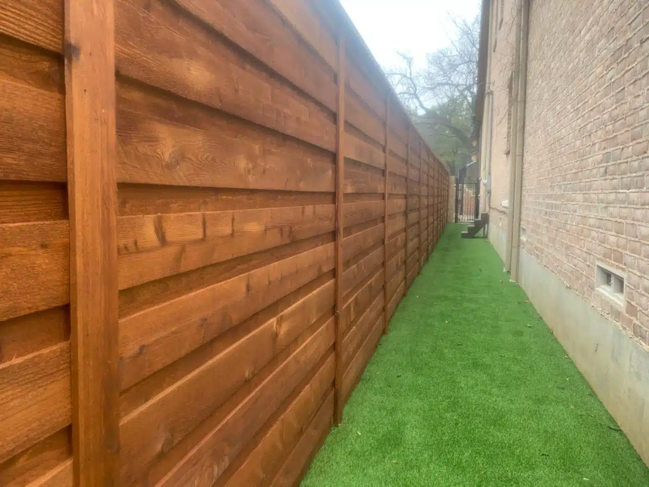 Horizontal cedar boards running the length of the side yard