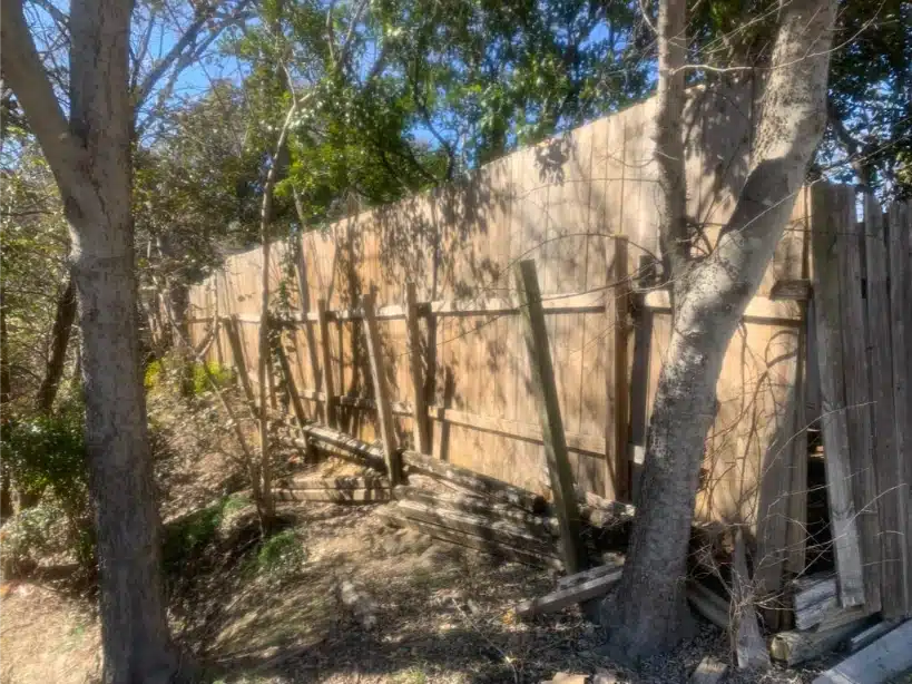 Failing fence line with broken boards and shifted posts