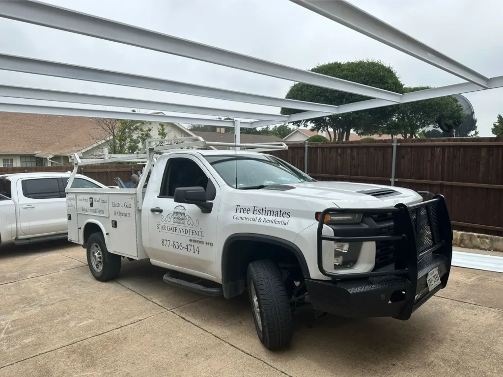 White Star Gate and Fence truck parked under partially built metal carport frame by professional carport builders.