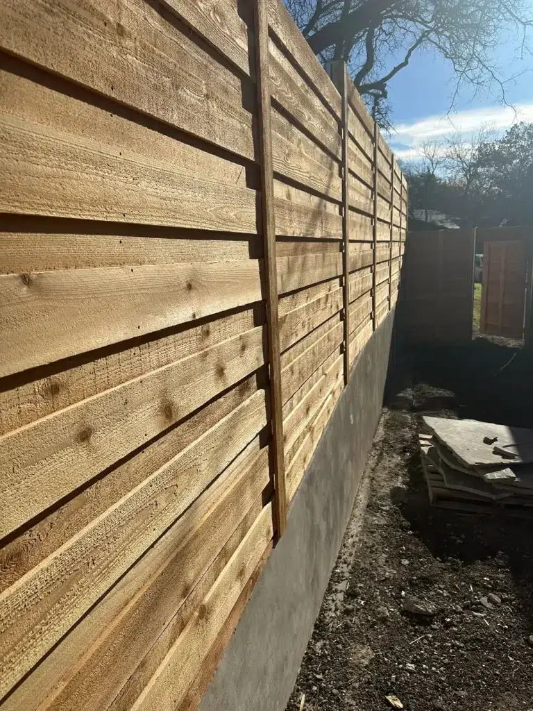 fence installation on retaining wall