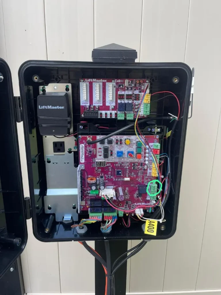 Open LiftMaster control box showing wiring and circuit boards for automated gates and openers.